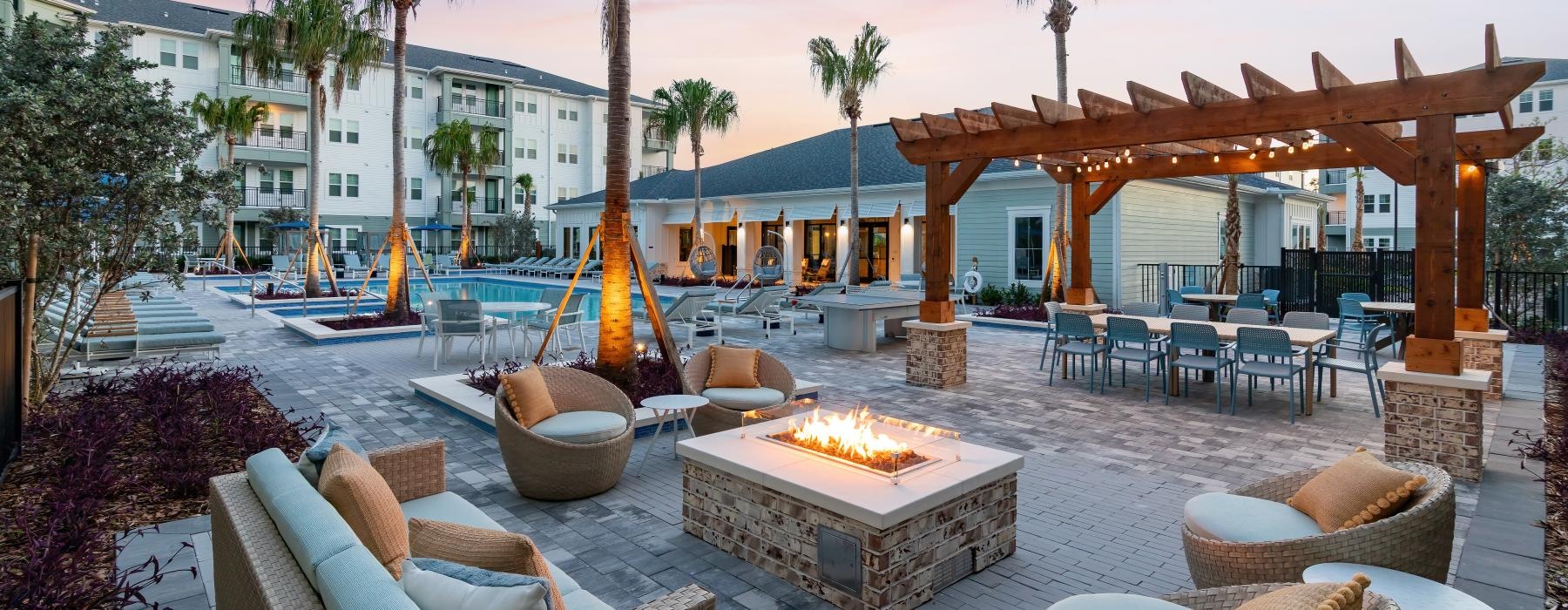 a patio with chairs and tables and umbrellas