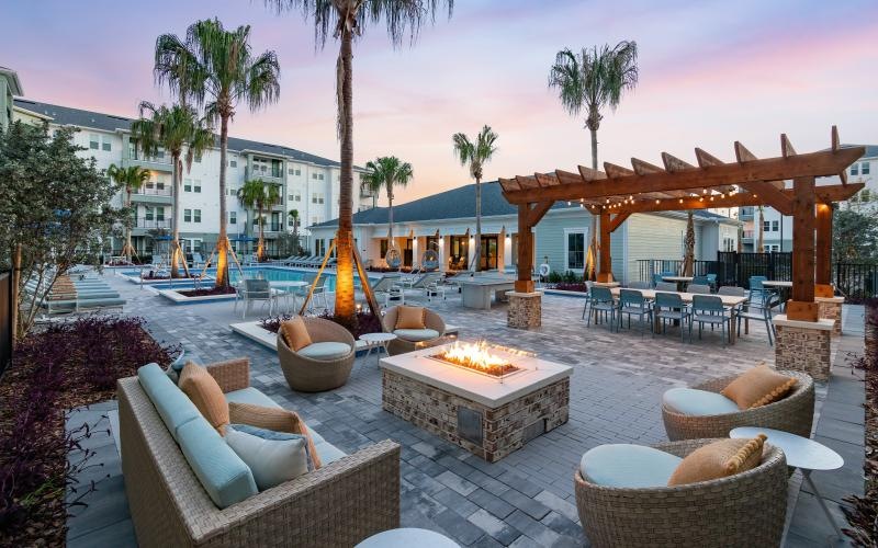 a patio with chairs and tables and umbrellas
